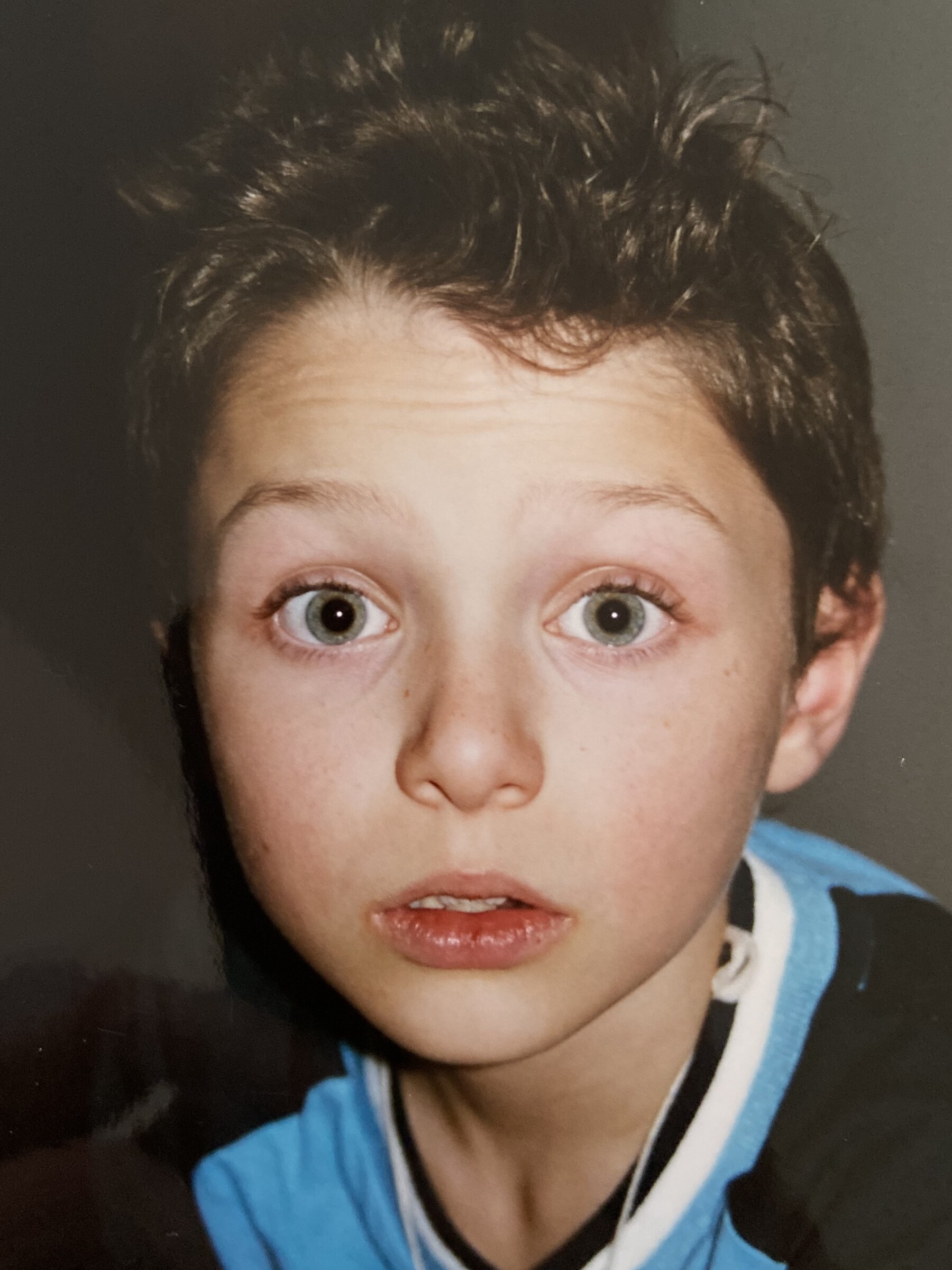 Childhood photograph of Brian Anthony Kelly, close-up portrait looking directly at the camera.